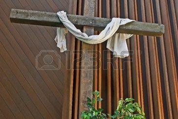 11163794-this-easter-cross-is-inside-a-church-with-a-white-cloth-draped-across-it–it-has-a-rustic-sign-writt